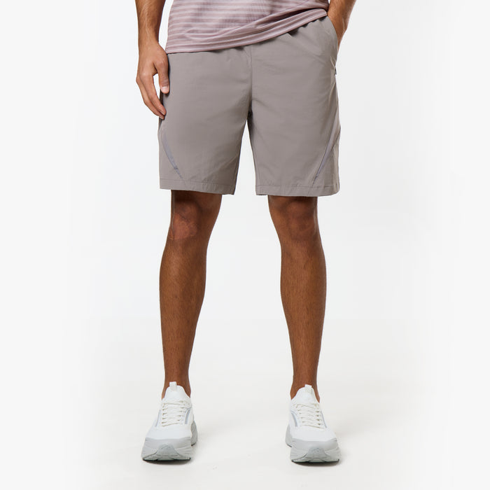 Model wears light grey shorts with details on the side from the Closure tri-set