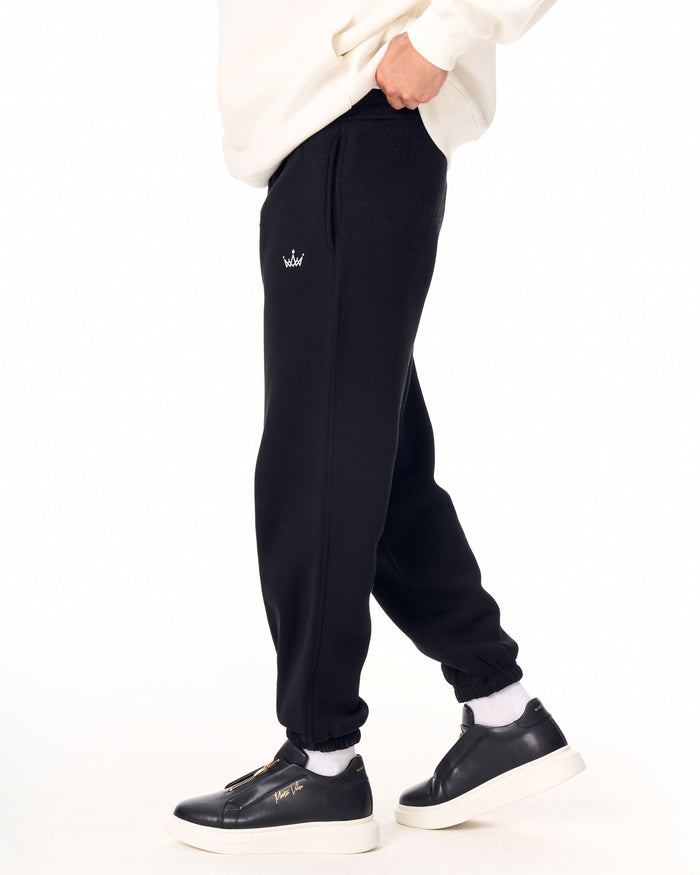 Martin Valen The Crown black jogger, three-quarter leg view with black zip-front sneaker visible