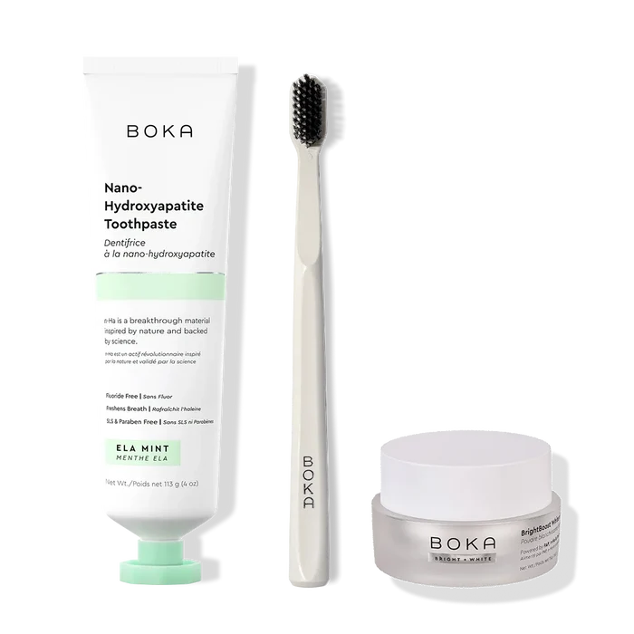 Boka toothpaste, toothbrush, and whitening powder on a white background