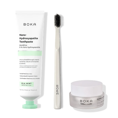 Boka toothpaste, toothbrush, and whitening powder on a white background