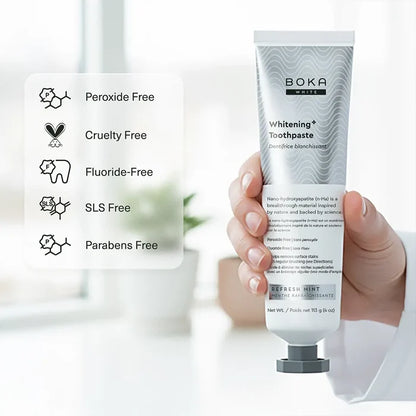 Boka Whitening Toothpaste tube held by a hand with product features listed on the left.