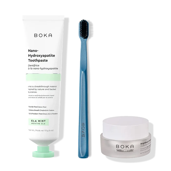 Boka toothpaste, toothbrush, and whitening powder on a white background