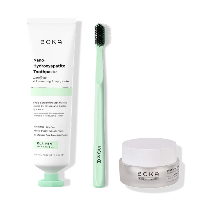 Boka toothpaste, toothbrush, and whitening powder on a white background