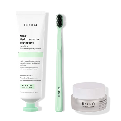 Boka toothpaste, toothbrush, and whitening powder on a white background