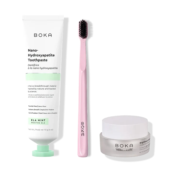Boka toothpaste, toothbrush, and whitening powder on a white background