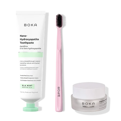 Boka toothpaste, toothbrush, and whitening powder on a white background