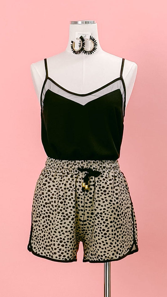 Mannequin wearing a black mesh-trimmed camisole, and taupe-and-black leopard-print shorts. Shop at www.thehouseofblondie.com