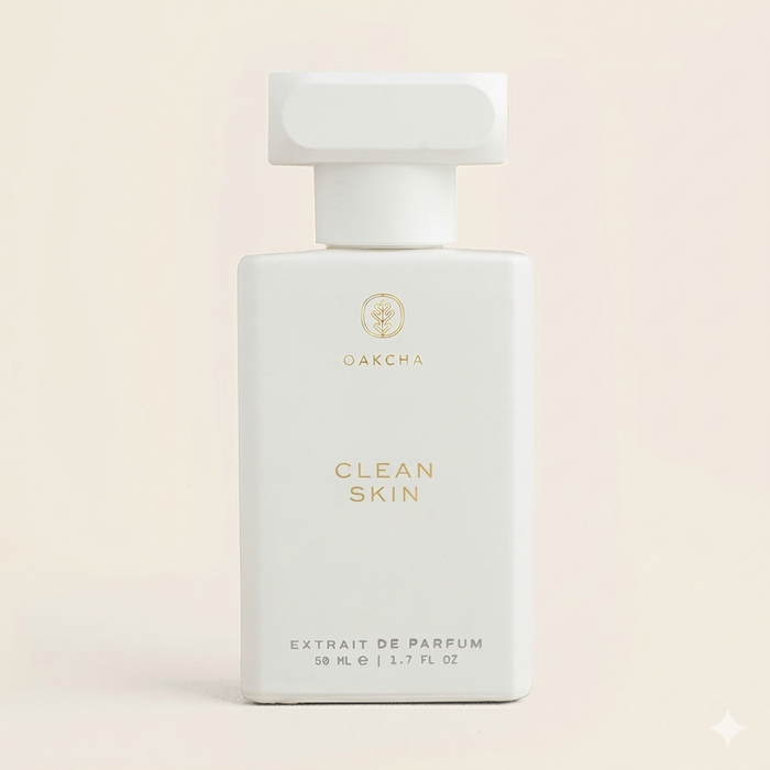 Front view of Clean Skin perfume bottle showcasing matte white rectangular bottle with gold logo on a pale cream background