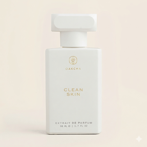 Front view of Clean Skin perfume bottle showcasing matte white rectangular bottle with gold logo on a pale cream background