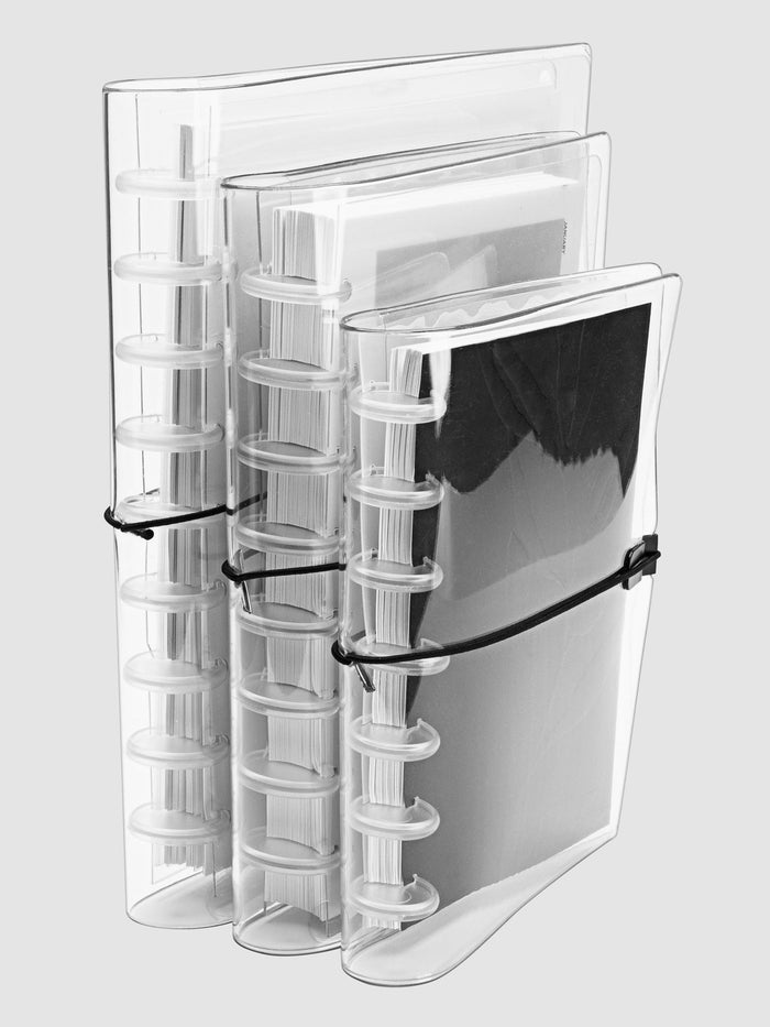 Small, Large, and HP Classic covers arranged in a row on a neutral background. Each cover is filled with a discbound planner system in respective sizing.