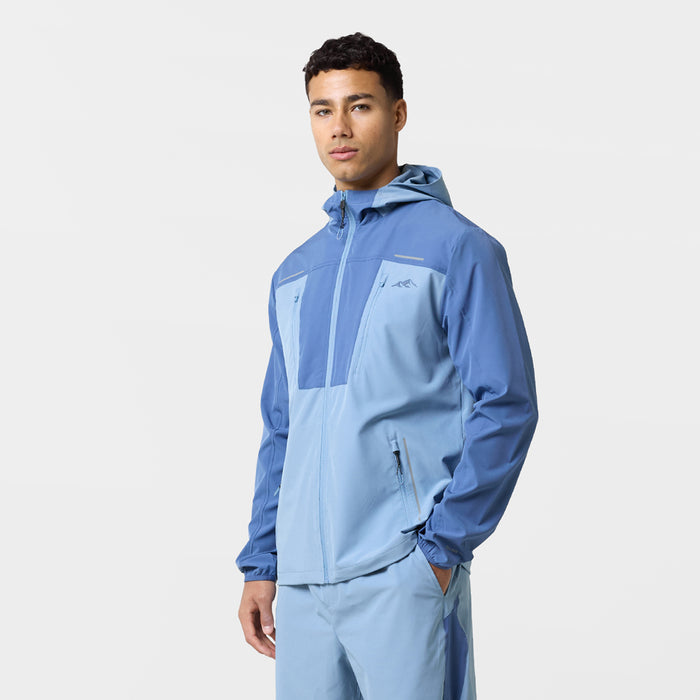 The model wears the light blue and sky blue windbreaker with pockets and matching shorts