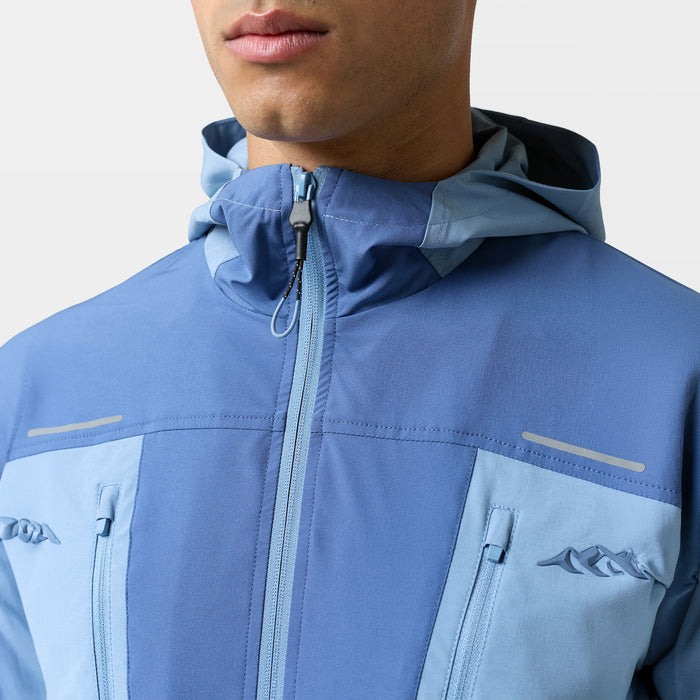Close up of the chest and neck of the Closure light blue windbreaker with logo and blue zip details