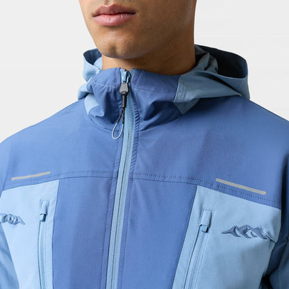 Close up of the chest and neck of the Closure light blue windbreaker with logo and blue zip details
