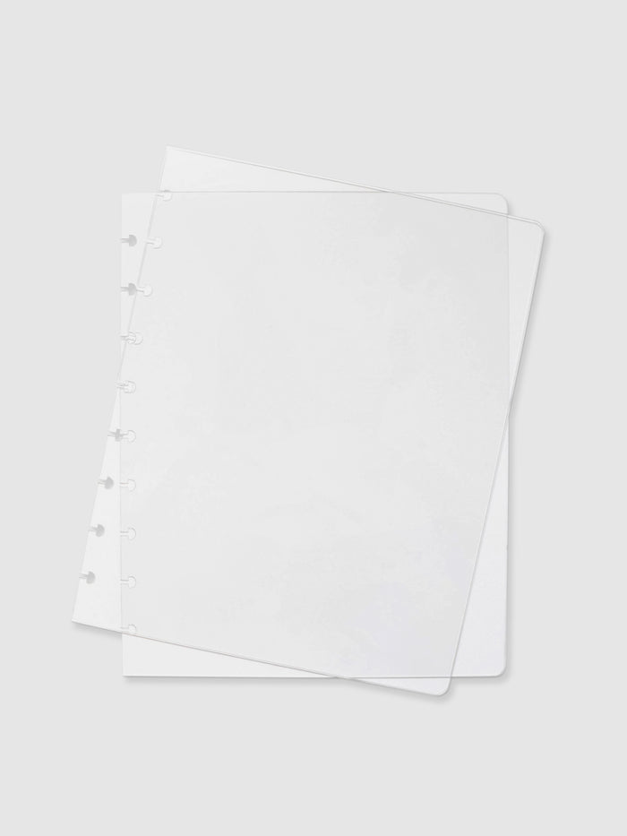 Crystal Clear Discbound Notebook Cover, HP Classic, Cloth and Paper. Two transparent notebook covers laid on top of one another with the top cover tilted slightly to the right.