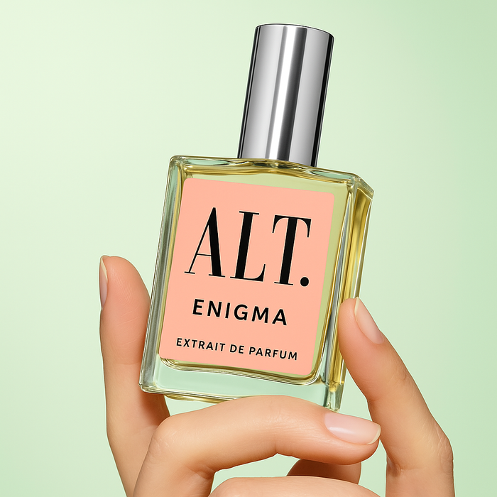 A hand holding ALT. Fragrance Enigma Perfume. Dupe for Prada Paradoxe