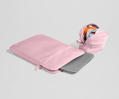 Pink laptop sleeve with a partially open view on a light gray background