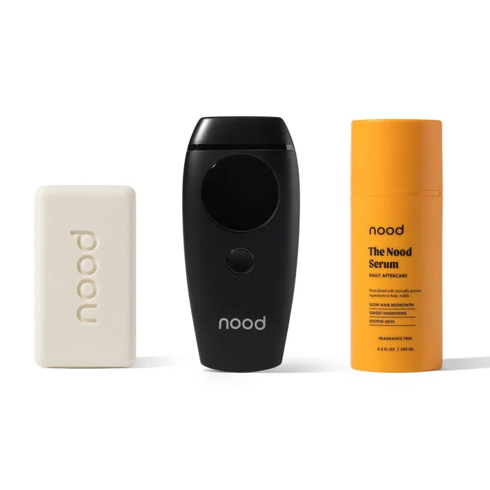 Nood Flasher 2.0 Kit in black including Buff Bar soap, Flasher 2.0 IPL device in matte black, and Nood Serum daily aftercare on white background