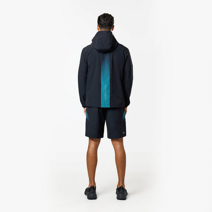 Model shows the gradient stripe on the back of the closure black and teal windbreaker and shorts