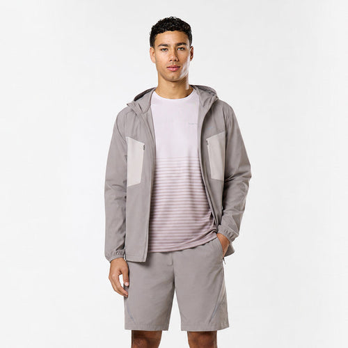 Model is wearing grey and white tri-set with shorts, gradient t-shirt and hooded windbreaker