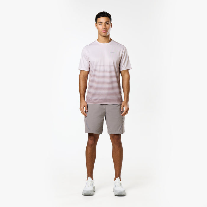 Model is wearing a grey and white gradient t-shirt and block grey shorts from  the Closure tri-set