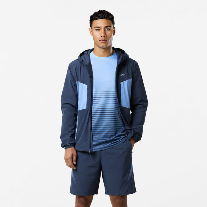 Model is wearing tri-set with navy shorts, a light blue tshirt with horizontal navy stripes and a dark blue hooded windbreaker.