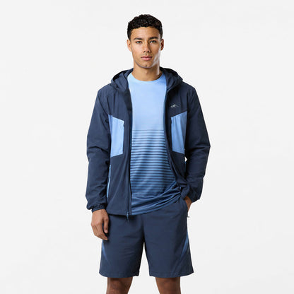 Model is wearing tri-set with navy shorts, a light blue tshirt with horizontal navy stripes and a dark blue hooded windbreaker.