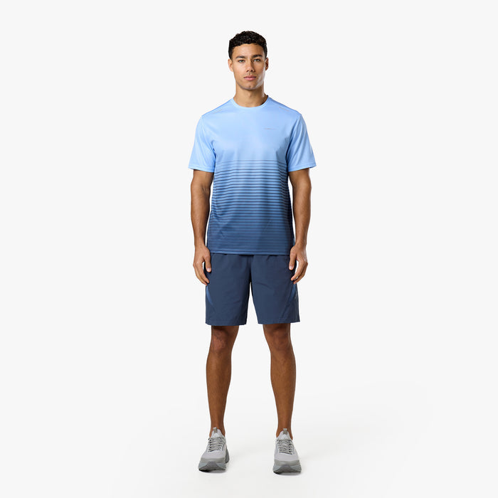Model is wearing a light blue top with a horizontal navy gradient and navy shorts from Closure tri-set.