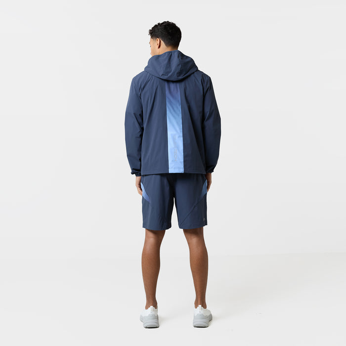 Image shows the back of a Closure navy wind breaker with vertical gradient stripe and matching navy tri-set shorts