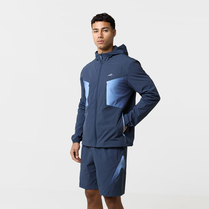 Model is wearing tri-set with navy gradient shorts and matching navy gradient hooded wind breaker.