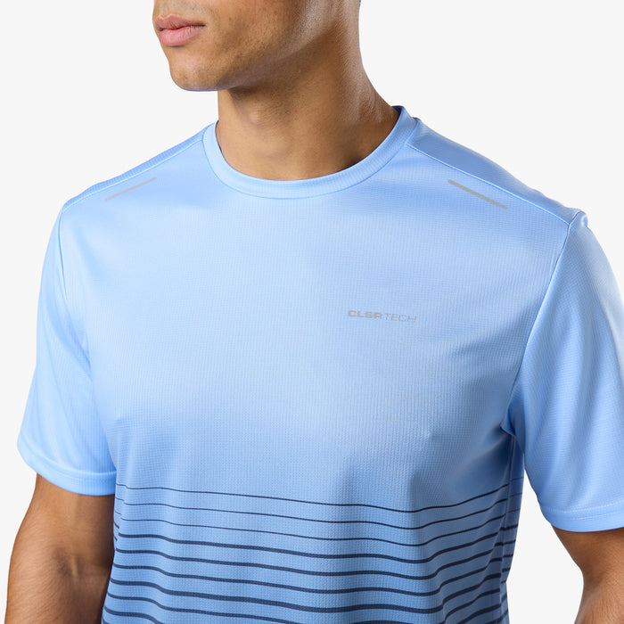 Model is wearing light blue technical t-short from tri-set with vertical navy stripes and Closure logo