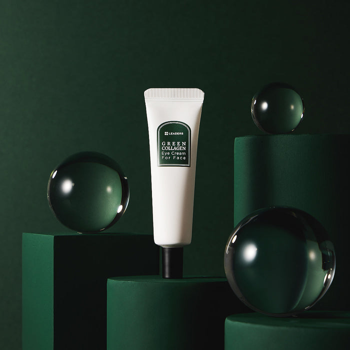 White tube of Green Collagen Eye Cream for Face | Leaders displayed on dark green geometric pedestals with reflective glass spheres, highlighting skincare and wellness.