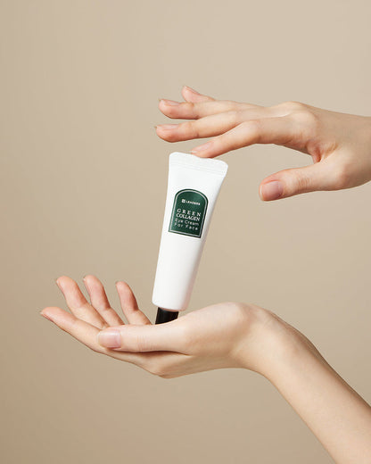 A tube of Green Collagen Eye Cream for Face | Leaders held delicately between two hands against a plain beige background, highlighting skincare and wellness care.