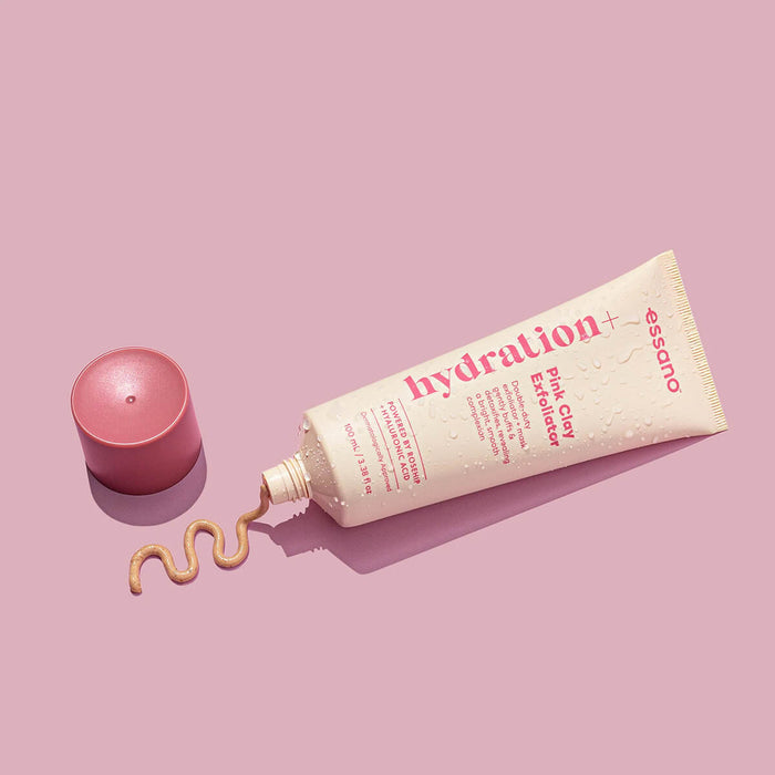 Tube of Hydration+ pink clay exfoliator with open cap on a pink background.