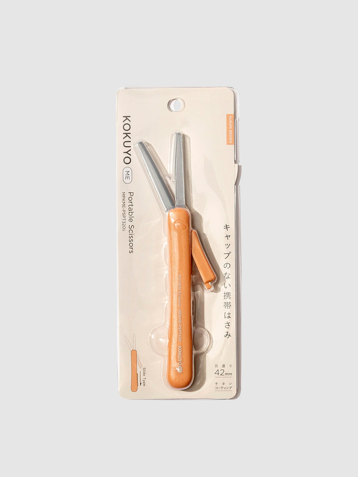 Kokuyo ME Portable Scissors, Kurumi Brown, Cloth and Paper. Scissors displayed in their packaging.