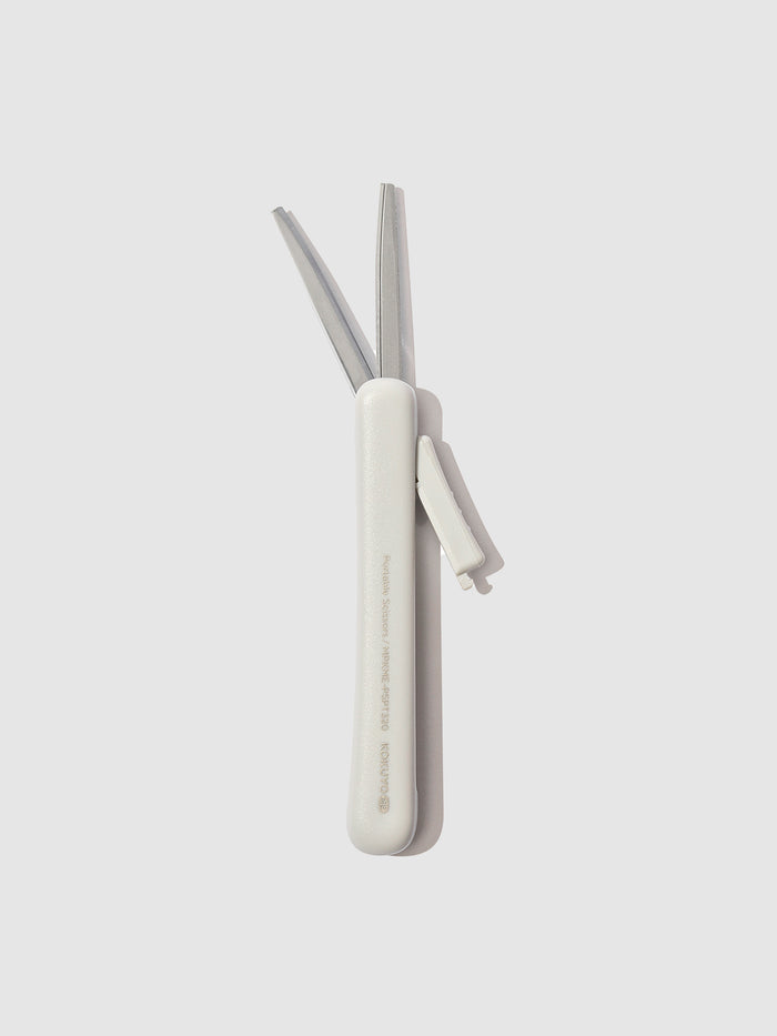 Scissors with blade exposed, displayed on a neutral background. Color shown is Grayish Ice.