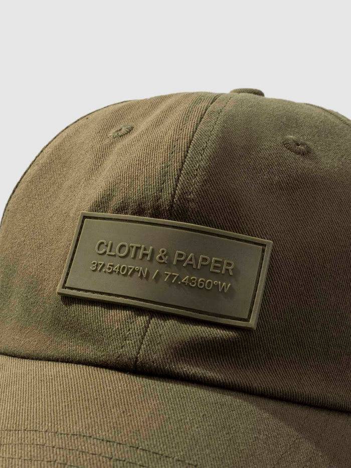 Label Hat, Cloth and Paper. Hat displayed on a neutral background. Closeup of silicone tag label.
