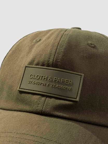Label Hat, Cloth and Paper. Hat displayed on a neutral background. Closeup of silicone tag label.