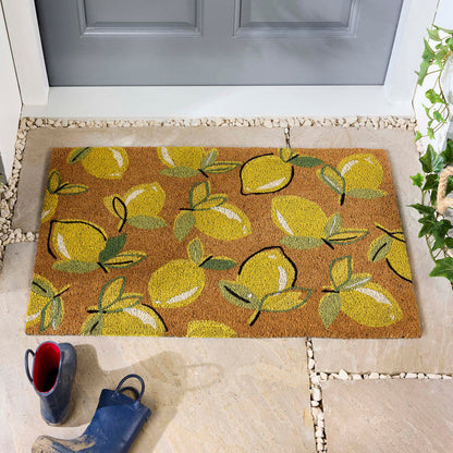 Lemons Yellow Coir Doormat with a multi-directional lemon pattern, styled in a doorway.