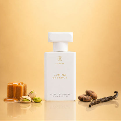 Front view of Lumina Essence with white rectangular bottle and caramel, pistachio, and vanilla on warm gold background