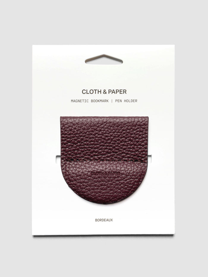 Magnetic Bookmark | Pen Holder in Bordeaux, a deep red, displayed on a white backing card against a neutral background.