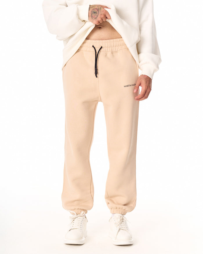 Martin Valen MV Basic beige jogger front view, visible black drawcord at waist and printed logo on thigh