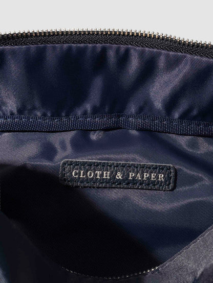 Closeup of interior of bag. A vegan leather tag is inside the bag with "Cloth & Paper" stamped on it with silver foil.