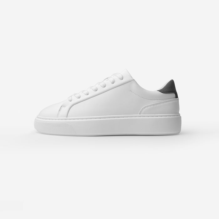 Side view of the Premium Classic Trainer in White/Grey, featuring a clean white PU upper, grey faux suede heel, white lace-up fastening and cushioned cup sole.