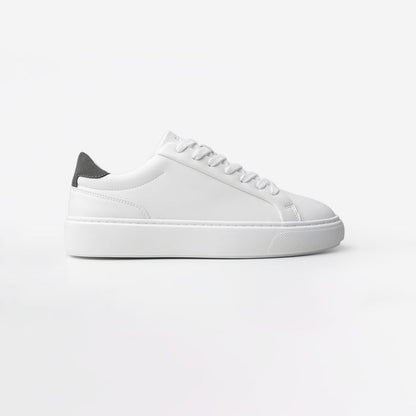 Side view of the Premium Classic Trainer in White/Grey, featuring a white PU upper, grey faux suede heel, white lace-up fastening and lightweight cushioned cup sole.