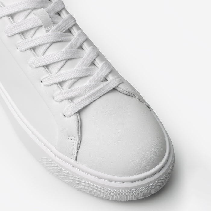 Close-up of the Premium Classic Trainer in White/Grey, highlighting the smooth white PU toe box, tonal lace-up fastening, stitching and textured cup sole.