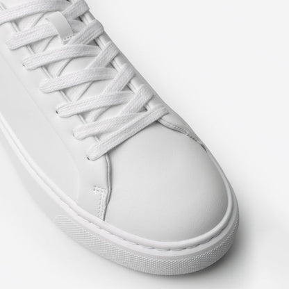 Close-up of the Premium Classic Trainer in White/Grey, highlighting the smooth white PU toe box, tonal lace-up fastening, stitching and textured cup sole.