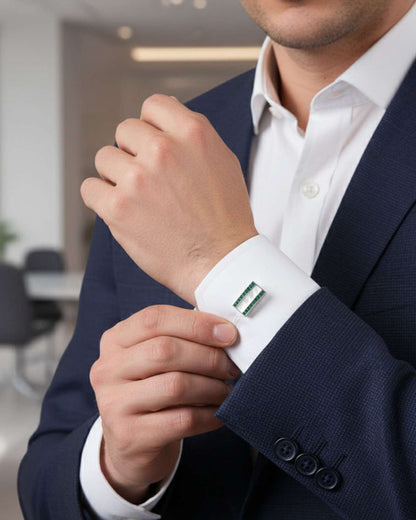 Men's shirt cuff with silver cufflinks featuring green crystal and mother-of-pearl inlay