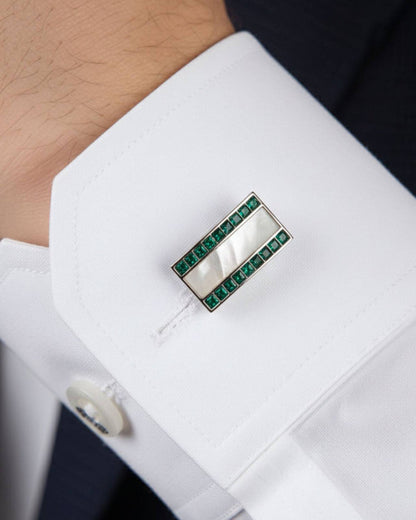 Silver cufflinks with green crystal border and mother-of-pearl center on white shirt