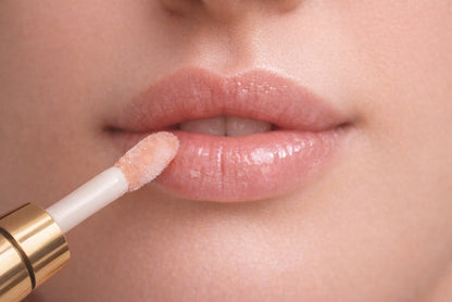 Applicator applying Reiland Velvet Lip Plumper to lips in a close-up application shot with a natural finish.