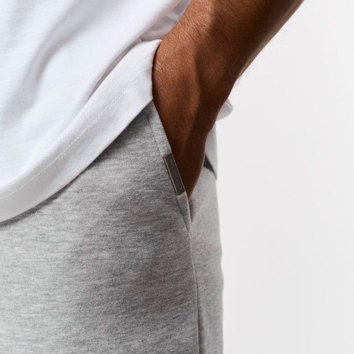 Close up branded detailing on pocket of tracksuit bottoms